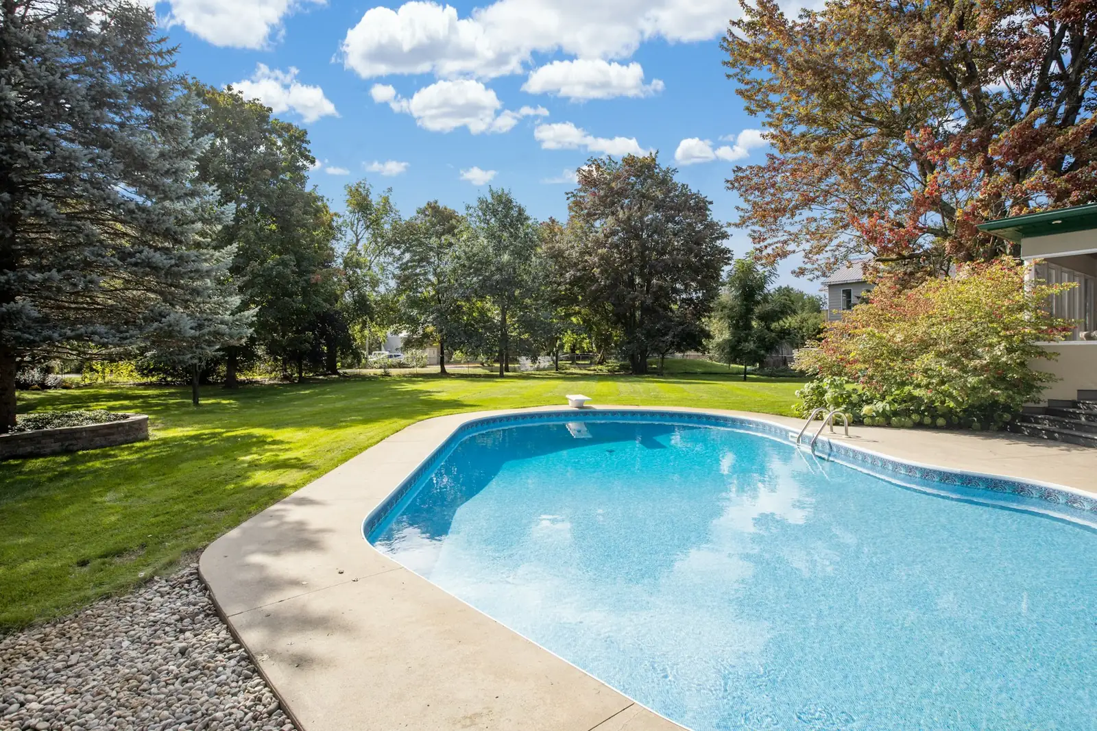 Crystal-clear backyard swimming pool on a sunny day
